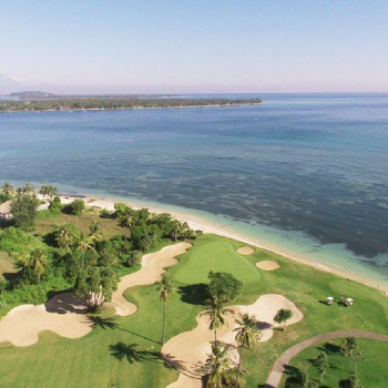 aerial view of a golf field by the sea